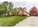 Expansive backyard with lush green grass, brick exterior, and basketball court at 14297 Matt St, Carmel, IN 46033