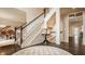 Elegant foyer with grand staircase, piano, and dark hardwood floors at 14297 Matt St, Carmel, IN 46033