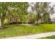 Charming brick home with mature trees, a lush lawn, and manicured landscaping, creating a welcoming curb appeal at 14297 Matt St, Carmel, IN 46033