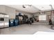 Spacious garage with gray epoxy floors and built-in storage cabinets, perfect for organizing tools and equipment at 14297 Matt St, Carmel, IN 46033