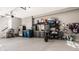 Organized garage with clean epoxy floors, storage cabinets, refrigerator, and space for parking, offering functionality and convenience at 14297 Matt St, Carmel, IN 46033