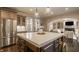 Open concept kitchen features island with bar seating, stainless fridge, and ample storage space at 14297 Matt St, Carmel, IN 46033