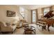 Bright living room with comfortable seating, grand piano, and large windows showcases an inviting space at 14297 Matt St, Carmel, IN 46033