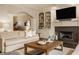 Cozy living room featuring a fireplace, built-in shelving, and comfortable seating at 14297 Matt St, Carmel, IN 46033
