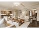 Spacious living room with tray ceiling, hardwood floors, and arched entryways to other rooms at 14297 Matt St, Carmel, IN 46033