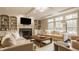 Bright living room featuring a fireplace, built-in shelving, and a large window at 14297 Matt St, Carmel, IN 46033