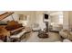 Inviting living room featuring a grand piano and a cozy fireplace, perfect for relaxation and entertainment at 14297 Matt St, Carmel, IN 46033