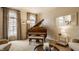 Elegant living room with a grand piano, arched windows, and neutral décor creates a welcoming ambiance at 14297 Matt St, Carmel, IN 46033