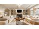 Comfortable living room with built-in shelving surrounding the fireplace and large windows at 14297 Matt St, Carmel, IN 46033