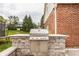 Built-in outdoor grill featuring a stainless steel grill and brick surround, perfect for backyard entertaining and summer cookouts at 14297 Matt St, Carmel, IN 46033