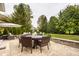 Inviting patio with an outdoor dining set, lounge chairs, and lush greenery, ideal for relaxing and enjoying the outdoors at 14297 Matt St, Carmel, IN 46033