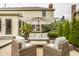 The covered patio is perfect for relaxing, featuring comfortable seating and beautiful landscaping at 14297 Matt St, Carmel, IN 46033