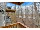 Wood balcony overlooking a wooded area and waterway with multi-level decks at 14474 Treasure Creek Ln, Fishers, IN 46038