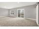 Spacious basement featuring natural light from windows and sliding glass doors and a modern sliding barn door at 14474 Treasure Creek Ln, Fishers, IN 46038