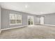 Large open basement with neutral carpet, gray walls, a barn door, and sliding door to a balcony at 14474 Treasure Creek Ln, Fishers, IN 46038