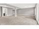 Finished basement with gray walls, carpet, and architectural columns and an entrance to an attached bathroom at 14474 Treasure Creek Ln, Fishers, IN 46038