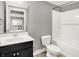 Bathroom with dark vanity, white toilet, and tiled shower/tub combo at 14474 Treasure Creek Ln, Fishers, IN 46038