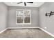 Bright bedroom features a ceiling fan, neutral paint, and large window with outdoor views at 14474 Treasure Creek Ln, Fishers, IN 46038