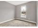 Bedroom featuring neutral paint and carpet, plus a window offering neighborhood views at 14474 Treasure Creek Ln, Fishers, IN 46038