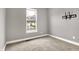 Bright bedroom with a window offering a view of the neighborhood and a TV mount on the wall at 14474 Treasure Creek Ln, Fishers, IN 46038