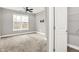 Bright bedroom has a large window, ceiling fan, TV mount, and access to closet space at 14474 Treasure Creek Ln, Fishers, IN 46038