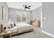 Comfortable bedroom with natural light, a ceiling fan, and neutral decor for a relaxing atmosphere at 14474 Treasure Creek Ln, Fishers, IN 46038