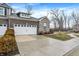 Charming townhome showcasing a two-car garage, stone facade, and well-maintained landscaping at 14474 Treasure Creek Ln, Fishers, IN 46038
