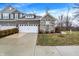 Charming townhome showcasing a two-car garage, stone facade, and well-maintained landscaping at 14474 Treasure Creek Ln, Fishers, IN 46038