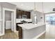 Bright kitchen with an island, stainless steel appliances, modern finishes, and access to the laundry room at 14474 Treasure Creek Ln, Fishers, IN 46038