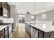 Modern kitchen featuring stainless steel appliances, an island with a sink, and a sliding glass door to a balcony at 14474 Treasure Creek Ln, Fishers, IN 46038