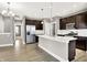 Modern kitchen features stainless steel appliances, a large island, hardwood floors, and ample cabinet space at 14474 Treasure Creek Ln, Fishers, IN 46038