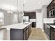 Modern kitchen features stainless steel appliances, a large island, hardwood floors, and ample cabinet space at 14474 Treasure Creek Ln, Fishers, IN 46038