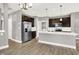 Modern kitchen features stainless steel appliances, a large island, hardwood floors, and ample cabinet space at 14474 Treasure Creek Ln, Fishers, IN 46038