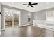 Spacious living room with hardwood floors, modern ceiling fan, natural light, and a balcony view at 14474 Treasure Creek Ln, Fishers, IN 46038