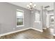 Bright living room with hardwood floors, neutral paint, a modern light fixture, and large windows at 14474 Treasure Creek Ln, Fishers, IN 46038