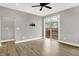 Living room with wood flooring, neutral paint, and access to outdoor balcony at 14474 Treasure Creek Ln, Fishers, IN 46038