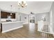 Open concept living room flows into the kitchen, with hardwood floors, neutral paint, and modern fixtures at 14474 Treasure Creek Ln, Fishers, IN 46038