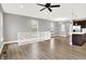 Open concept living room flows into the kitchen, with hardwood floors, neutral paint, and modern fixtures at 14474 Treasure Creek Ln, Fishers, IN 46038
