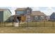 View of a fenced backyard with a manicured lawn, a patio area, and a well maintained landscaping at 15675 Woodford Dr, Westfield, IN 46074