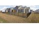 Well-maintained backyard with a black fence, green lawn, and view of neighboring homes, offering a serene outdoor space at 15675 Woodford Dr, Westfield, IN 46074