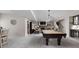 Basement features a pool table, fireplace, wet bar, and comfortable seating at 15675 Woodford Dr, Westfield, IN 46074