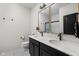 Modern bathroom with a double vanity and sleek black fixtures, complemented by tile flooring at 15675 Woodford Dr, Westfield, IN 46074