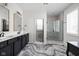 Bright bathroom featuring double sinks, modern fixtures, a glass-enclosed shower, and white and black decor at 15675 Woodford Dr, Westfield, IN 46074