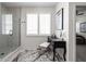 Bathroom featuring a glass enclosed shower and a black vanity table near a window with plantation shutters at 15675 Woodford Dr, Westfield, IN 46074