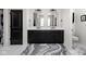 Bright bathroom features double sinks, a black door, and modern fixtures and neutral design touches at 15675 Woodford Dr, Westfield, IN 46074