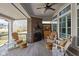 Inviting covered patio with a brick fireplace, comfortable seating, wood flooring, and outdoor charm for relaxation at 15675 Woodford Dr, Westfield, IN 46074