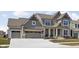 Beautifully landscaped house with a three-car garage and a well-maintained lawn at 15675 Woodford Dr, Westfield, IN 46074