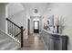 Inviting foyer with hardwood floors, staircase, elegant lighting, and decorative console table at 15675 Woodford Dr, Westfield, IN 46074