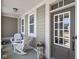 Charming front porch with rocking chairs, neutral siding, and a decorative front door at 15675 Woodford Dr, Westfield, IN 46074