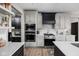 Modern kitchen features stainless steel appliances, white countertops, and ample cabinet space at 15675 Woodford Dr, Westfield, IN 46074